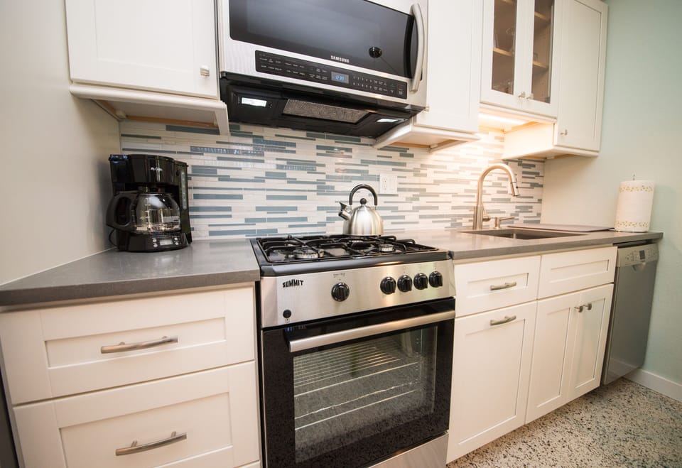 Natural gas range & ducted range hood microwave.