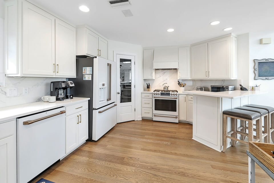 The Kitchen features white appliances with brass fittings.