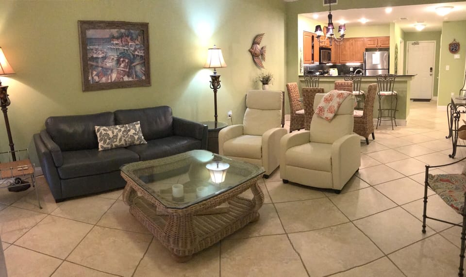 Roomy living area is comfortable/functional, fan, 2 recliners, ocean/beach view.