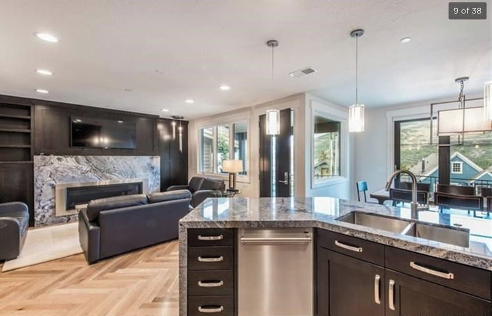 Open living room, dining room and kitchen with wonderful gas fireplace and patio