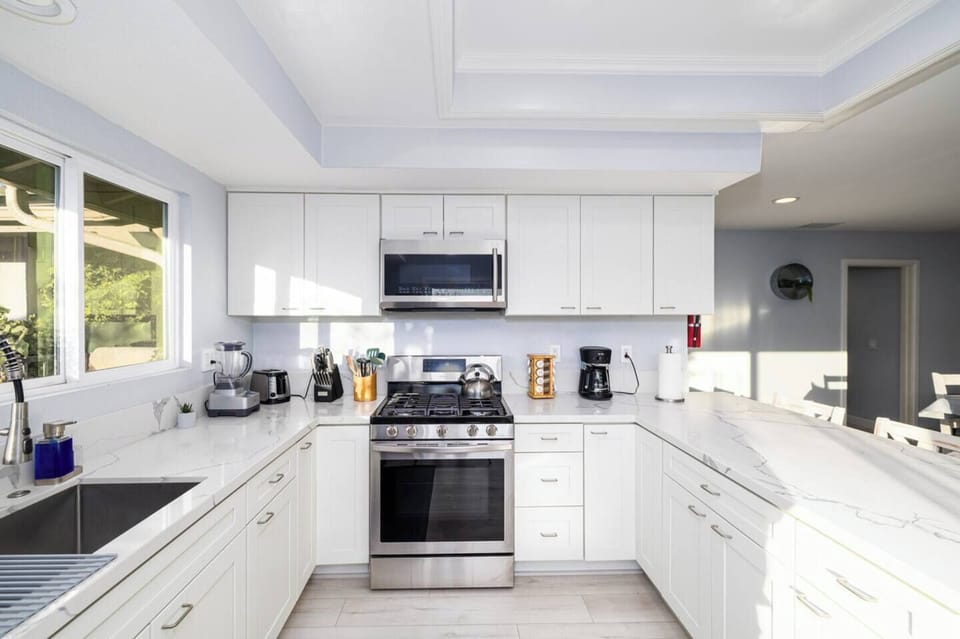 The kitchen is well stocked with cookware, utensils, silverware, and glassware. 