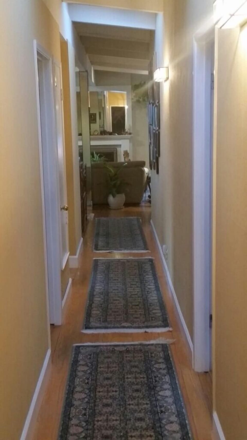 main floor hallway to three bedrooms and two baths
