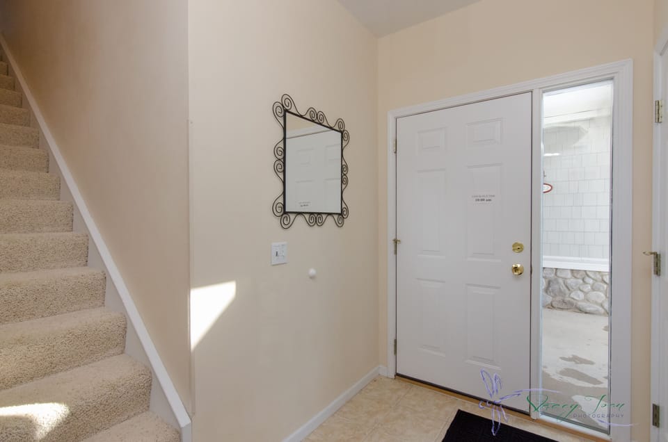 Entry door foyer stairs up to condo