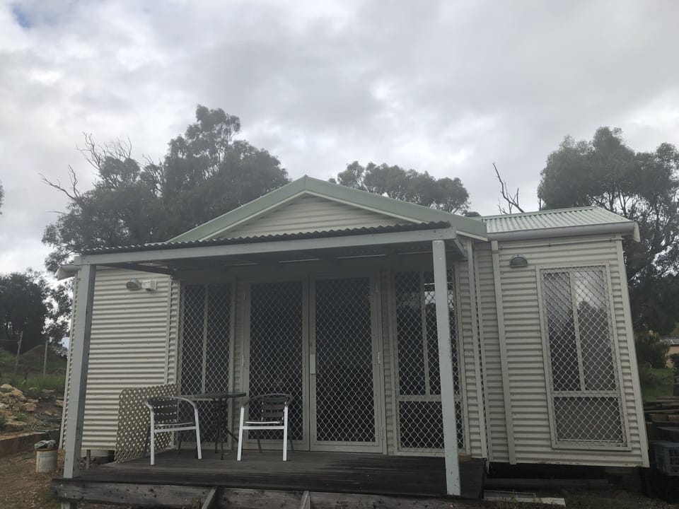 Green cottage terrace with garden and lake view