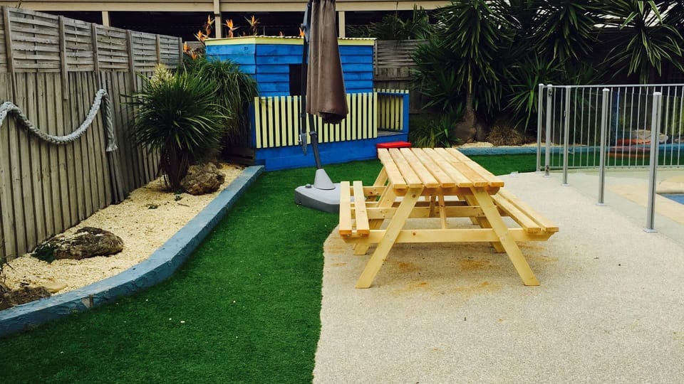 Back Yard, Outdoor tables and Umberella.  Cubby house & Swing set