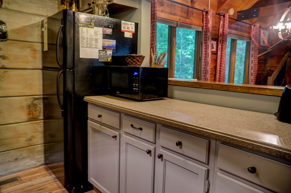 Medium sized microwave and full size refrigerator.