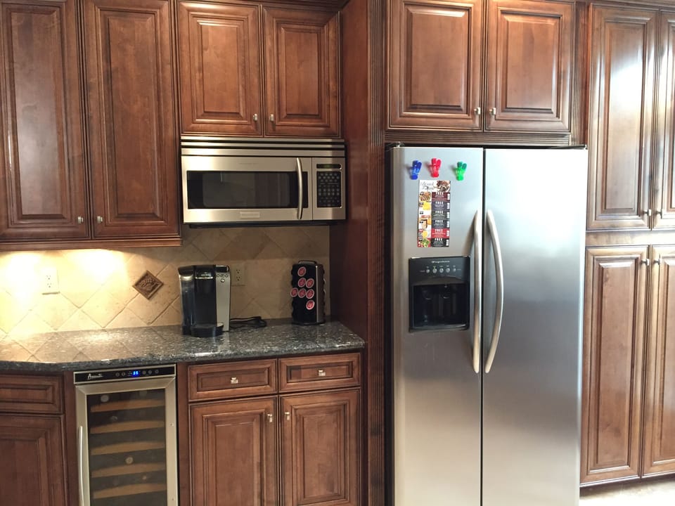 Stainless steel side by side refrigerator, wine fridge and coffee maker