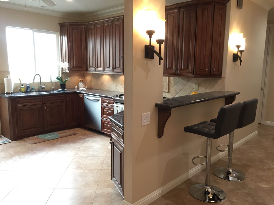 Sit on comfortable adjustable bar stools and keep the cook company.