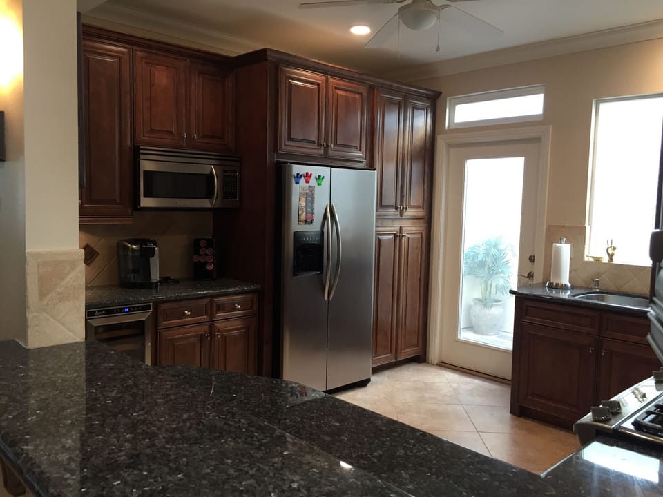Beautifully updated kitchen with solid custom cabinetry and granite counters