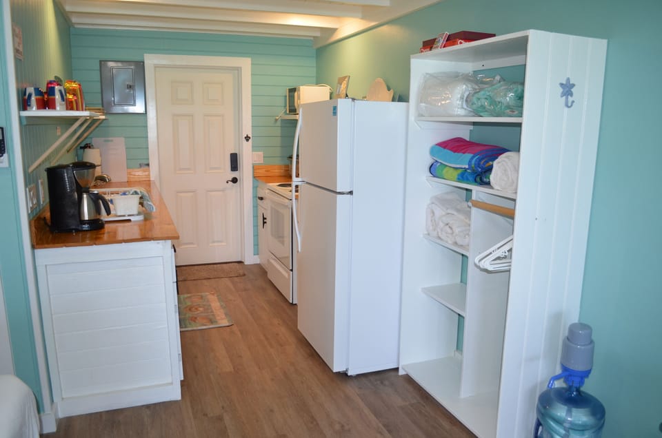 Kitchen includes coffee maker, microwave, toaster oven and utensils.