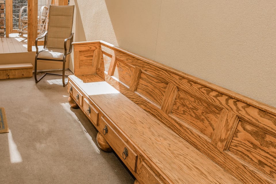 Bench at covered entrance to unit. Great for removing ski boots etc