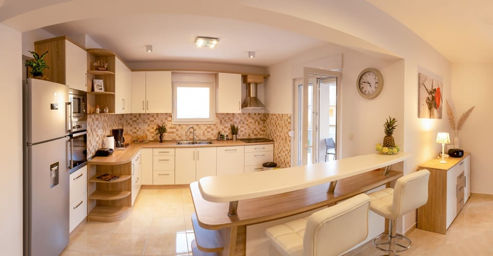 Kitchen has 4 induction cooktops, oven, dishwashing machine, microwave, kettle..