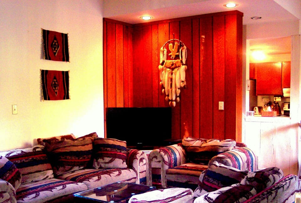 Living Room, flat screen and kitchen beyond.