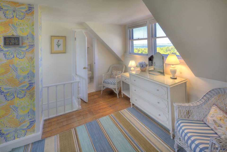 Second King bedroom upstairs, showing bathroom access and water view.