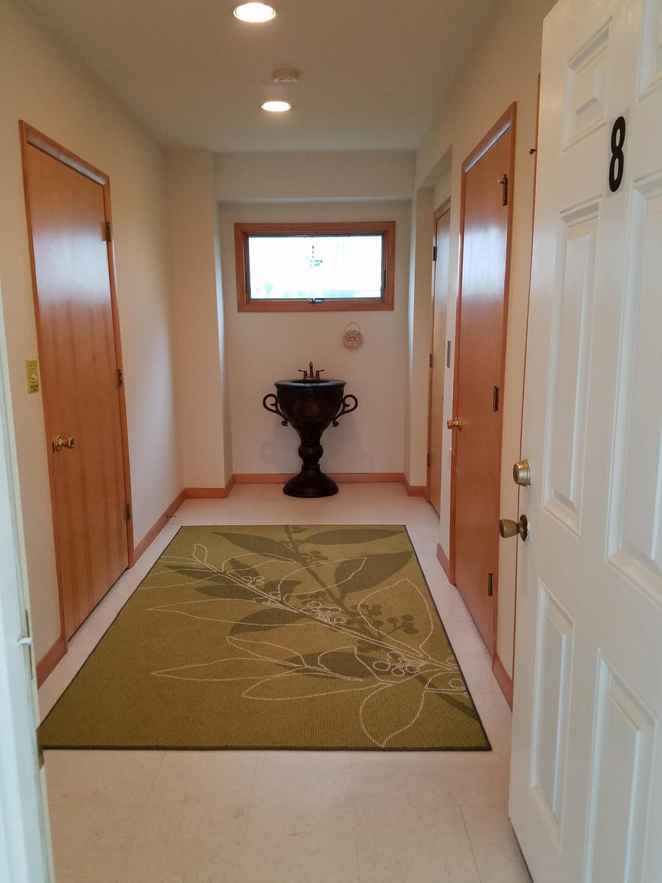 Downstairs entrance with doors to powder room and elevator