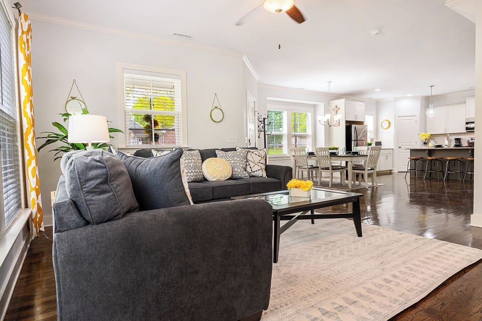 Open floor plan includes a cozy couch and love seat in the living room