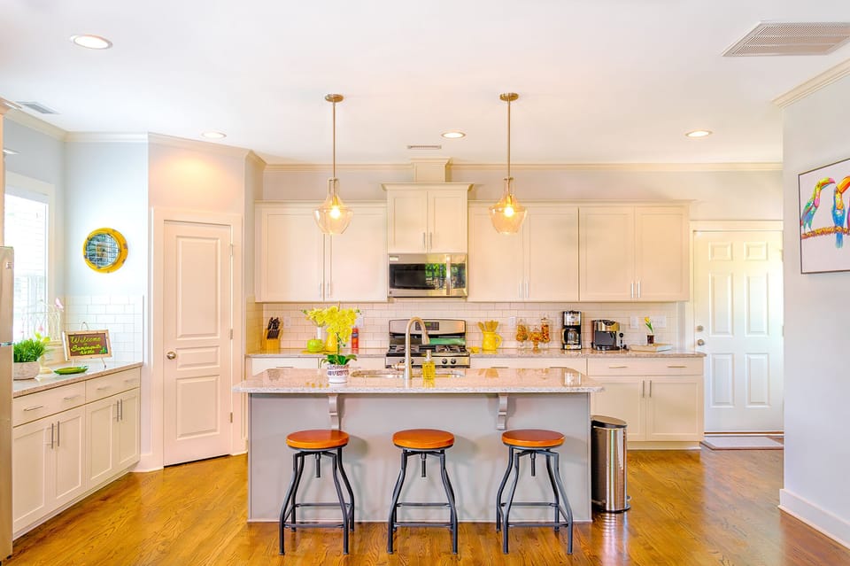 Open kitchen with nine foot ceiling. Island seats 3 people