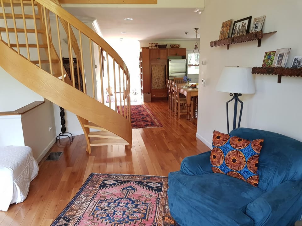 Living room and view of spiral staircase to second floor