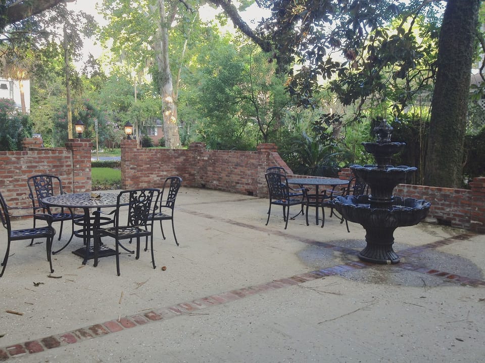 Courtyard dining with fountain and custom brick grill