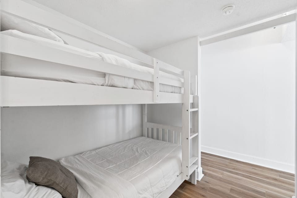 Bunkbed room with barn door and connected bathroom