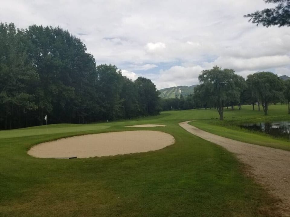 This is the golf course in the village, NCCC, with the view of Cranmore. The village is in between the course and the MT, This pic was taken standing next to the Saco River as well, so you can see how close the river is