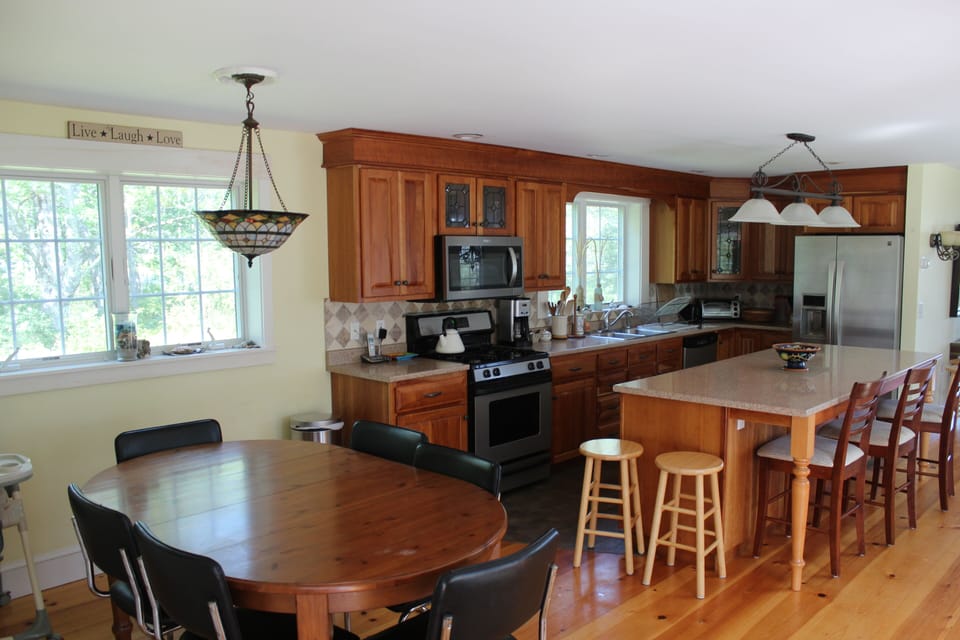 The bright, airy kitchen has plenty of space to cook, mingle, and enjoy the view