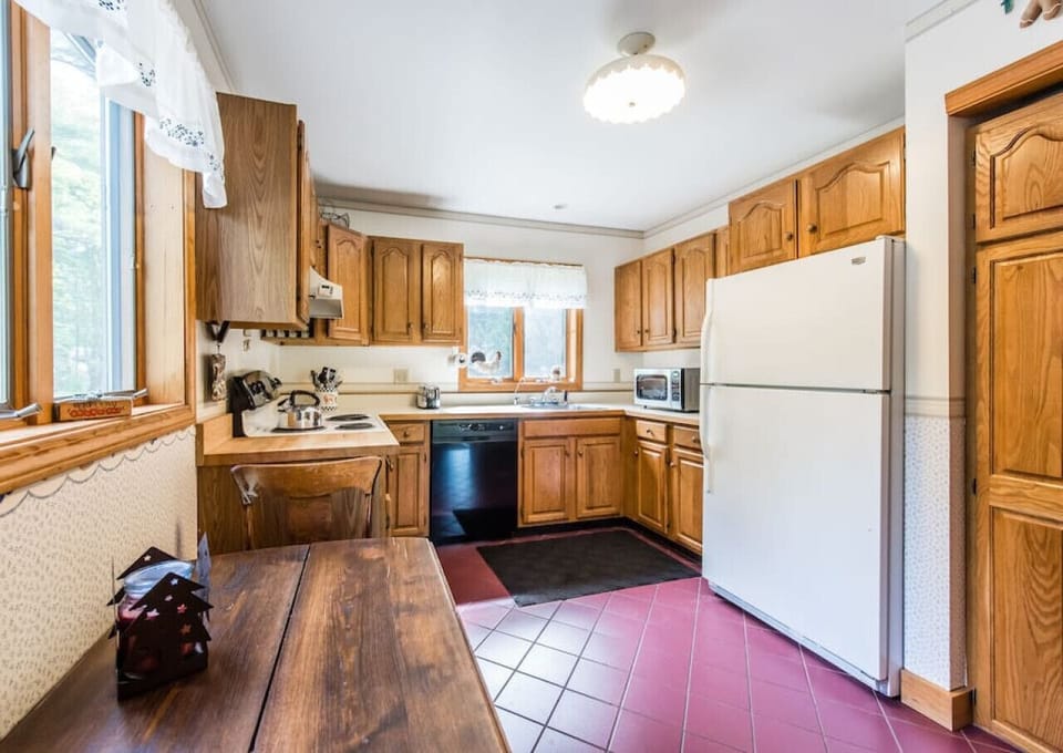 The kitchen is fully equipped with all the tools a cook would need, this is no sparse `rental kitchen`. Now has an extended counter top with barstools instead of small table.