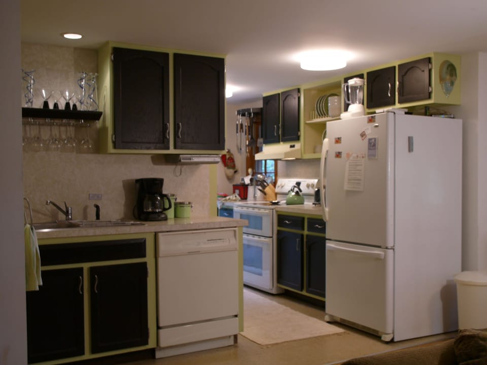 Modern, fully equipped kitchen with coffeemaker and lots of wine glasses. 