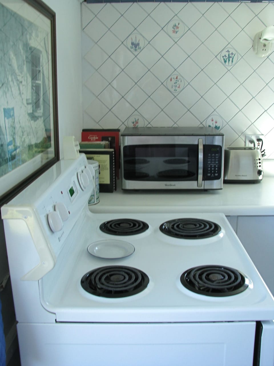 Our kitchen is well supplied with spices, herbs and cookbooks.