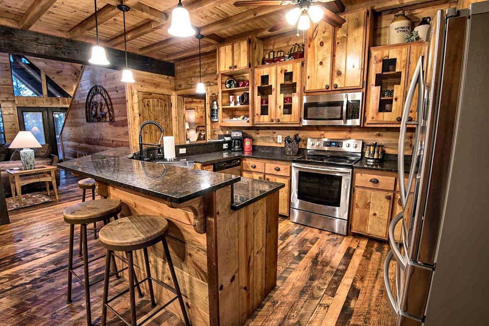 The kitchen has updated appliances and a bar top for additional seating.