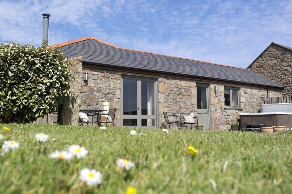 Exterior - sunny dining patio, hot tub, and large private garden. 
