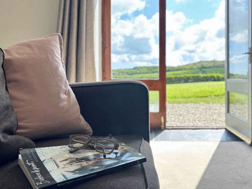 Open airy lounge with doors leading to the garden, views to Trencrom Hill.