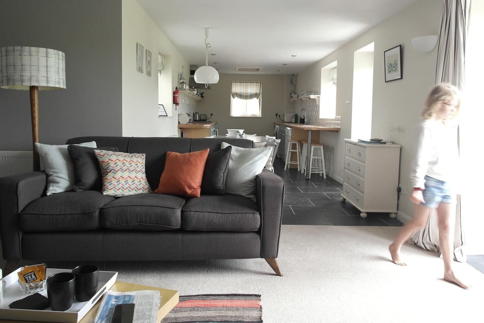 Living room, with dining table for 6 and spacious kitchen.