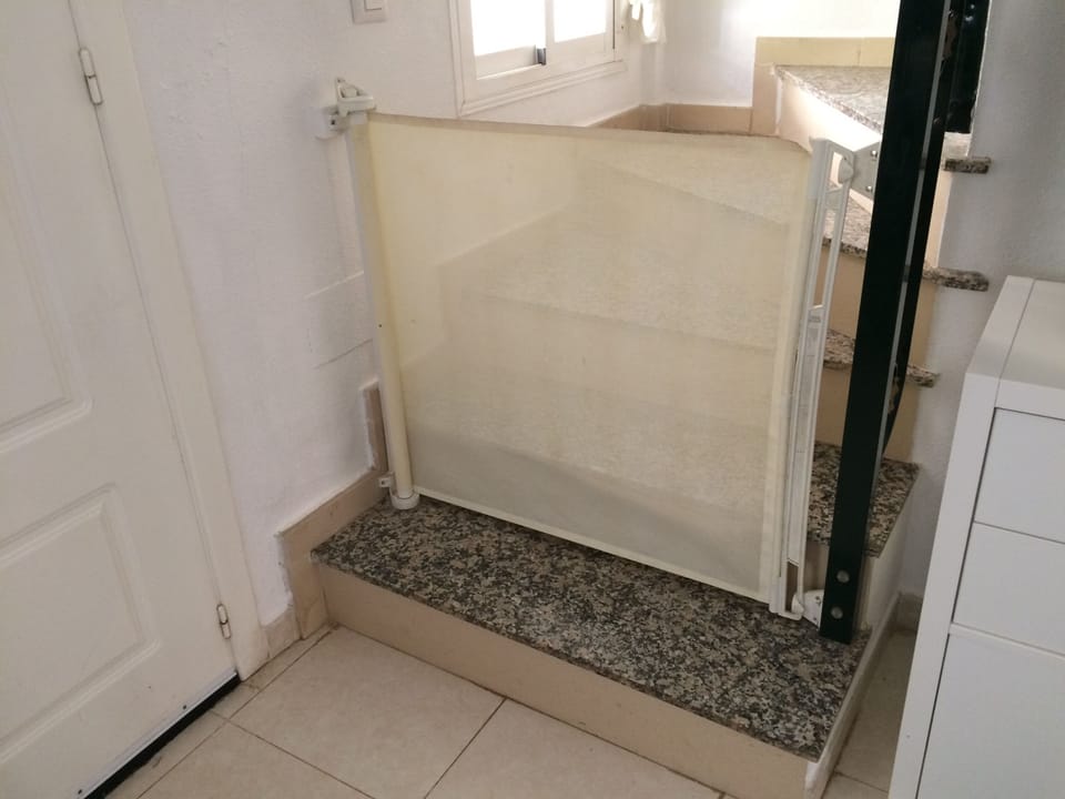 Stair gates both top and bottom of the marble staircase, ideal for little people