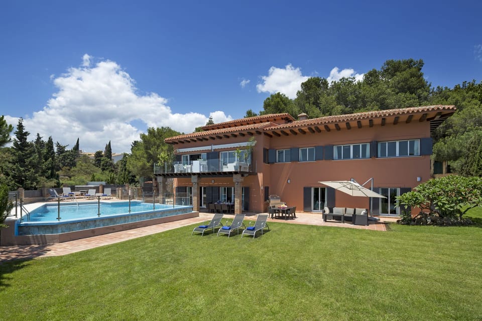 Large grassed garden, pool and villa.