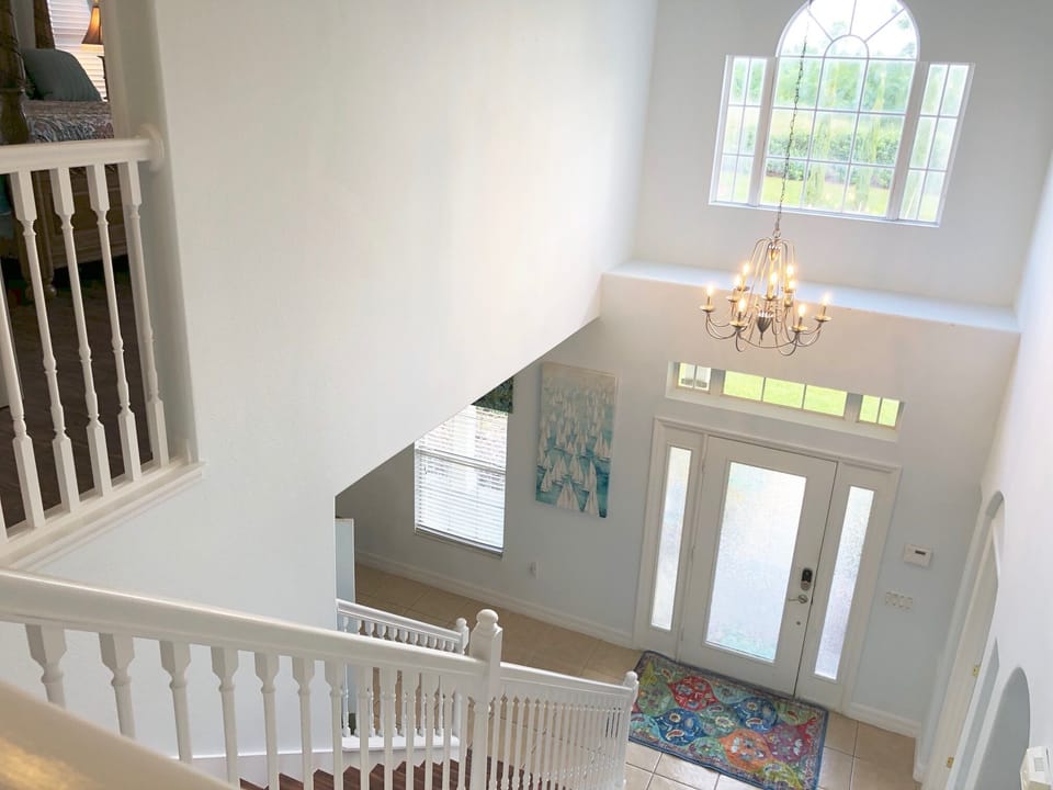 light filled hallway and feature staircase leads you upstairs