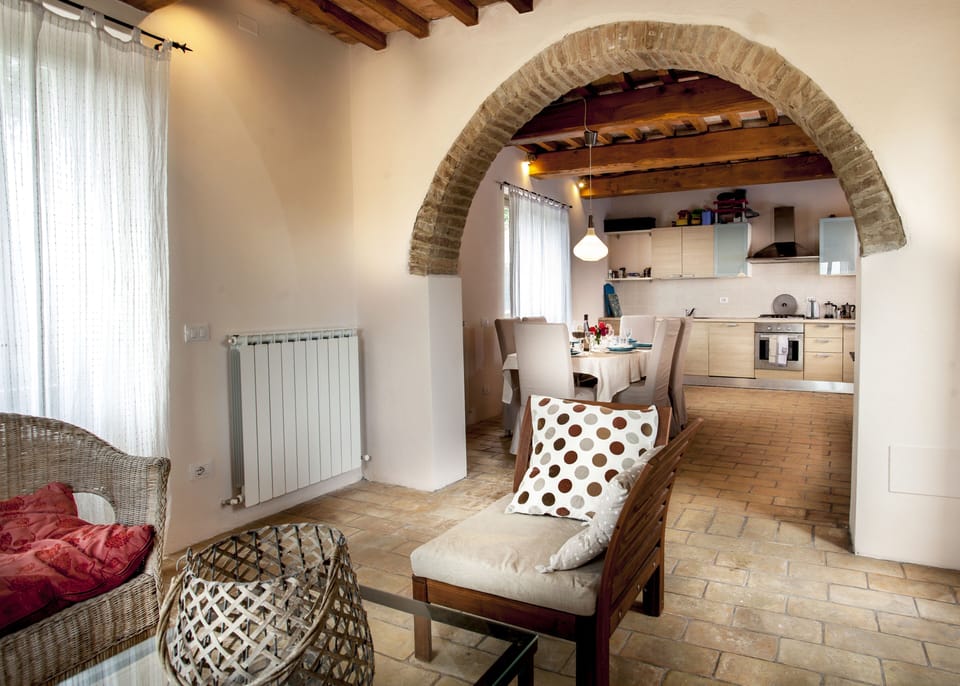 Small lounge at other end of open plan kitchen with doors to either side 