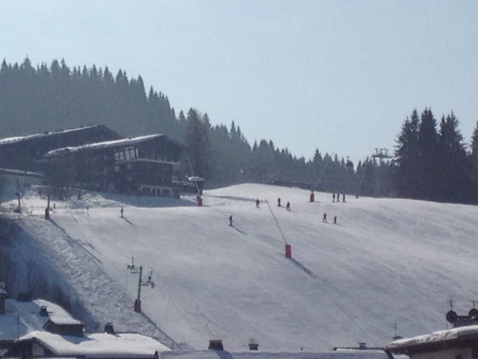 the apartment building and the main piste to the village