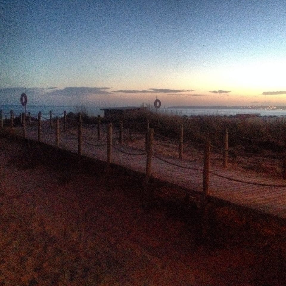 Boardwalk to Alvor Beach at sunset
