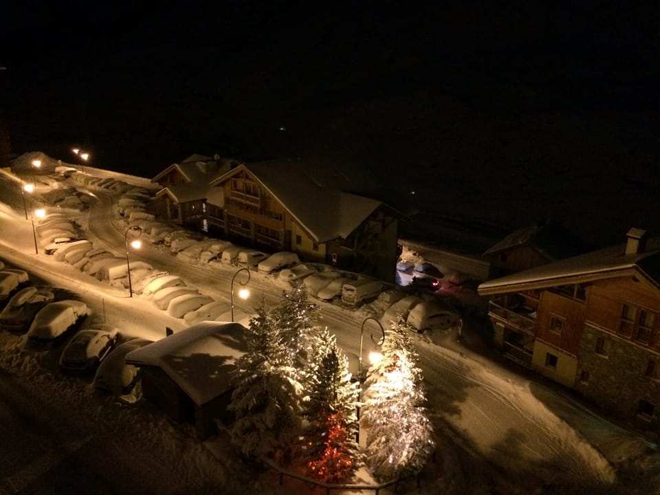 View of road below from balcony showing on street parking 
