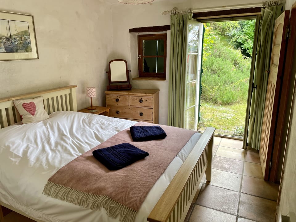 Ensuite double bedroom with king size bed and French windows to the garden