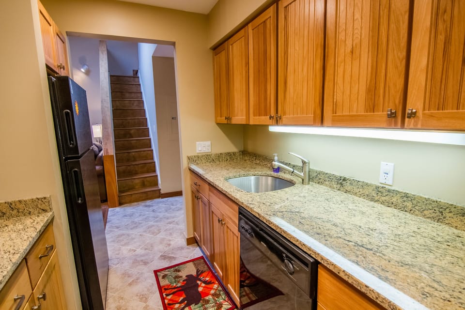 Upgraded Kitchen leads out into family room and stairs to 2nd floor loft