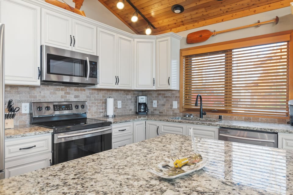 Well-appointed kitchen with granite countertops and stainless appliances.