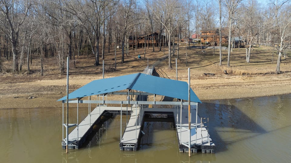 Double slip covered dock with sunbathing and swim plat form.