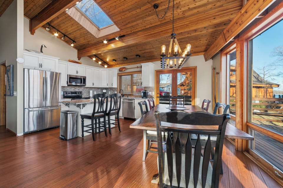 Dining area and kitchen with farmhouse table for ample seating.