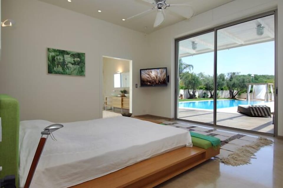 Master bedroom with direct access to garden and pool. Just jump in!