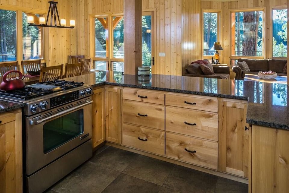 Kitchen view to living & dining room - sweeping views of the lake and forest