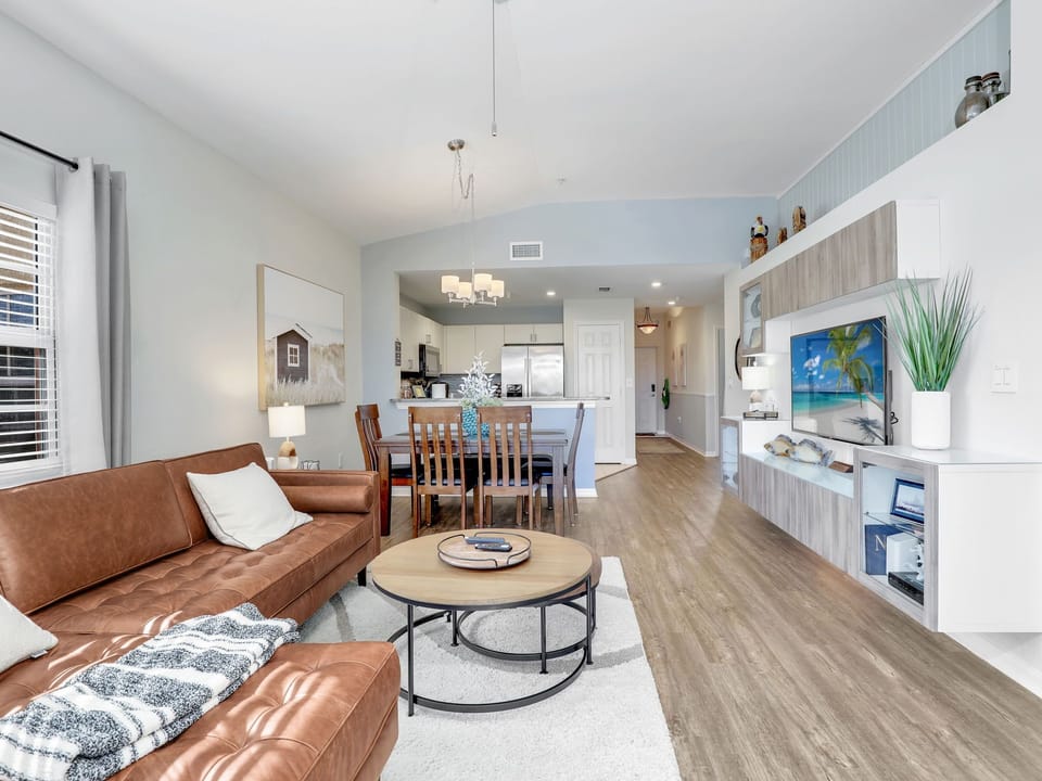 View of Living with Dining and Kitchen. Great lighting and vaulted ceilings