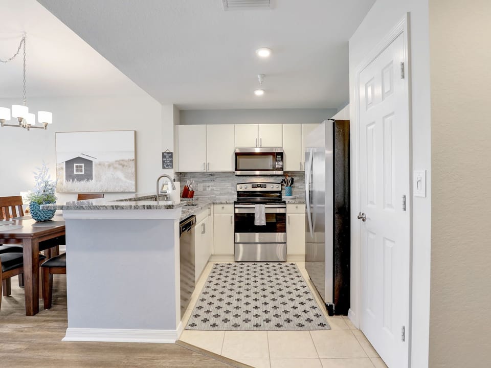 CLEAN kitchen has stove, micro, dishwasher, fridge and pantry.