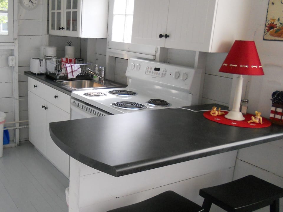 One view of the kitchen. Note the  bar stools.